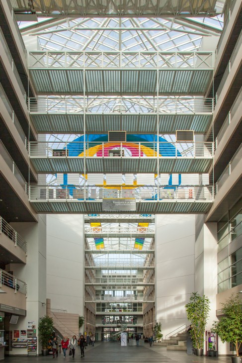 Soaring atrium of the Faculty of Translation and Interpreting at the University of Genoa with steel framework and skylights.