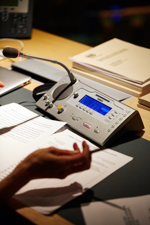 Taiden interpretation equipment with microphone and headphones on a desk with documents.