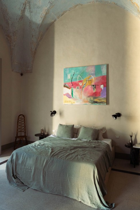 Palazzo Ventidue Puglia becroom with double bed art and vintage furniture