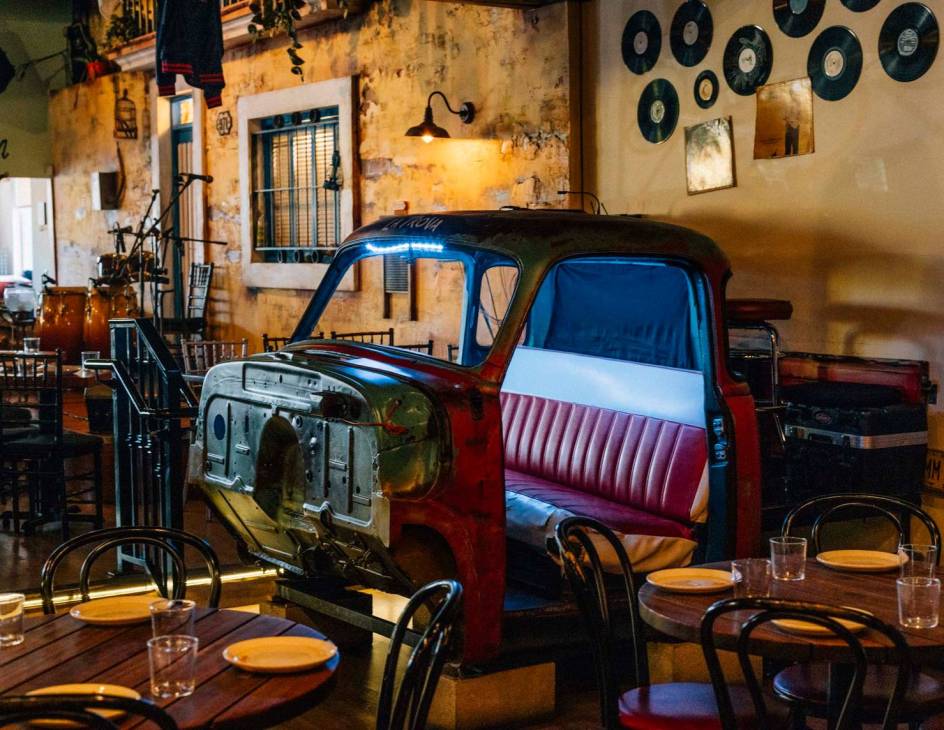 The front of a truck repurposed for seating in the dining area of Cafe La Trova.