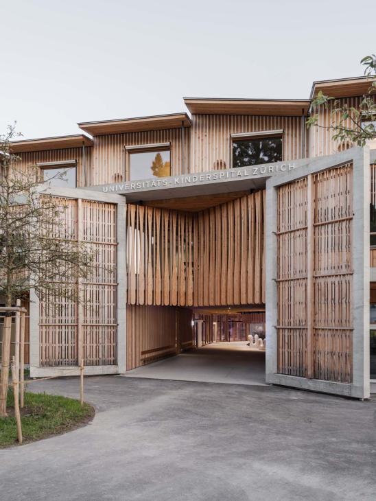 Spacious entrance framed by oversized wooden doors