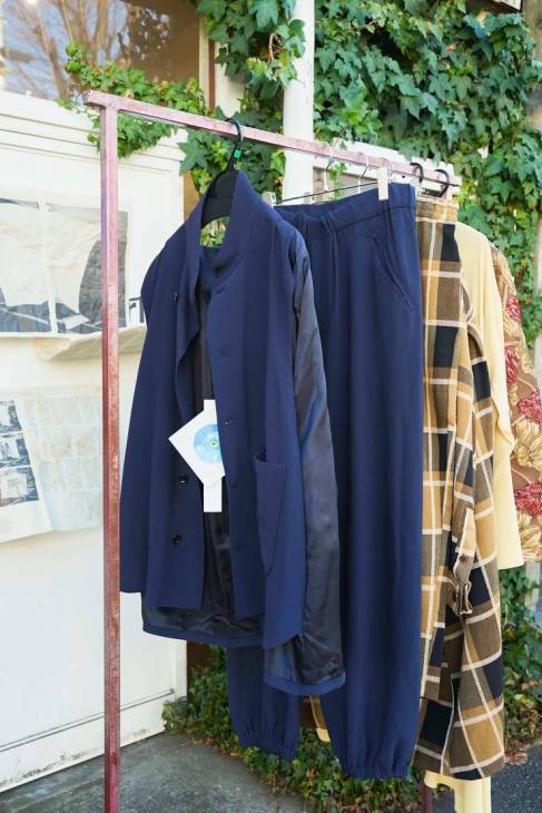 A clothes hanger with vintage clothing hung upon it.