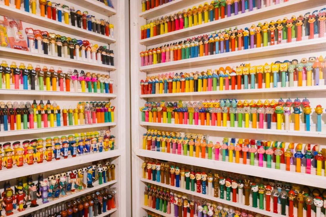 A shop display with shelves of different Pez dispensers.