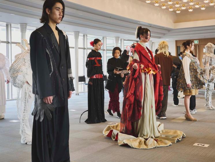 Judges look over the finalists in the design category of a competition at Bunka Fashion College, Tokyo