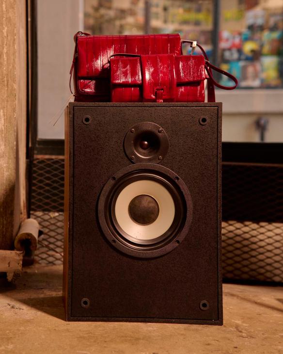 red women's bags on a speaker