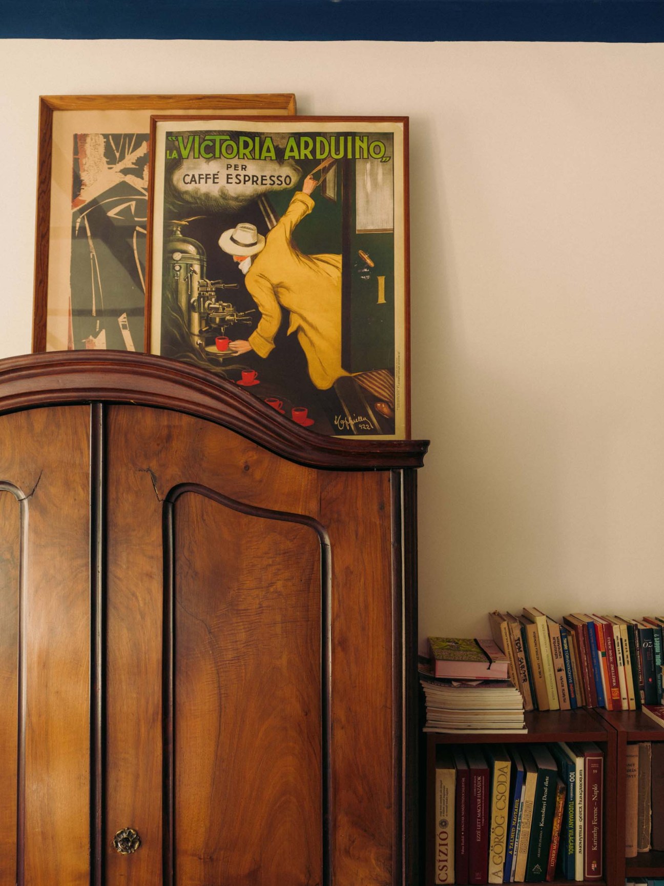 Framed illustrations on a wooden cabinet 