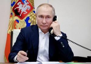 Russian President Vladimir Putin talks on the phone with Agatha Bylkova, a eight-year-old girl from the Kurgan region who took part in the New Year Tree of Wishes nationwide charity campaign, in Moscow on January 3, 2023.
