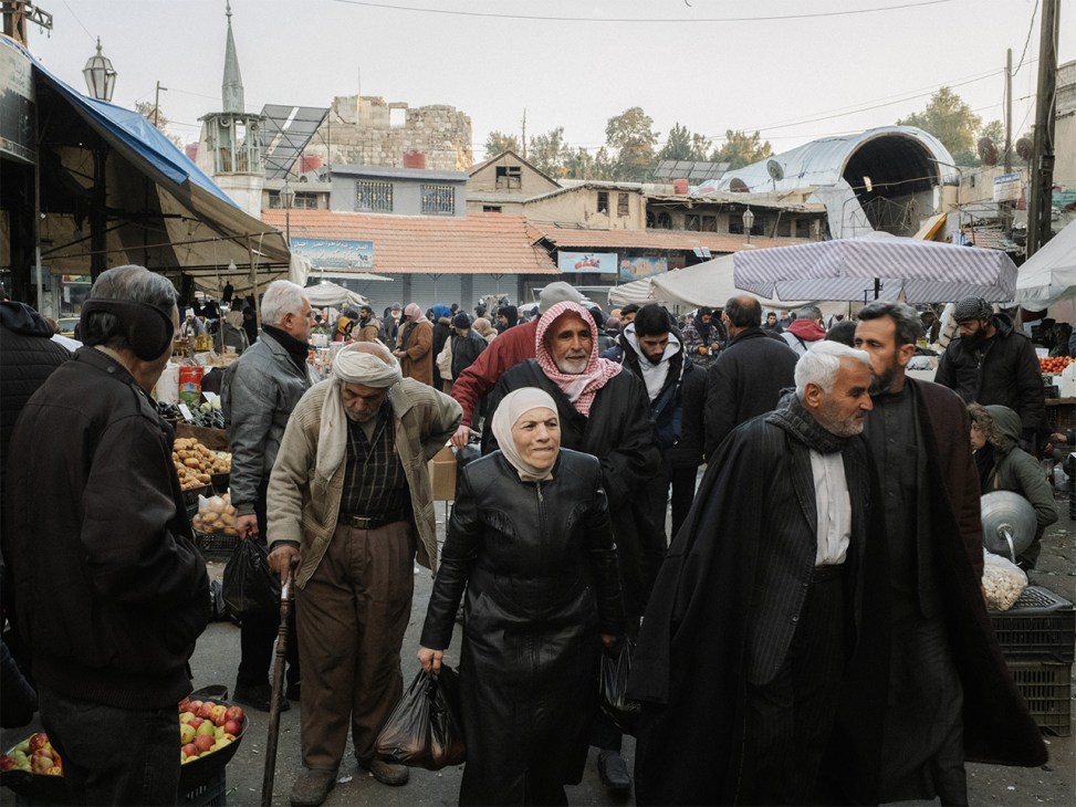 Syria, Damascus, 2025. People walk in an open market in Damascus centre.