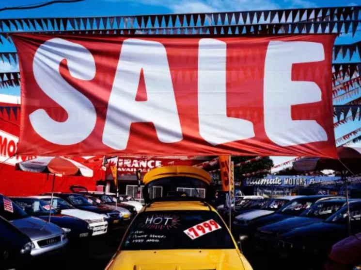 Enormous sale sign on a car showroom floor