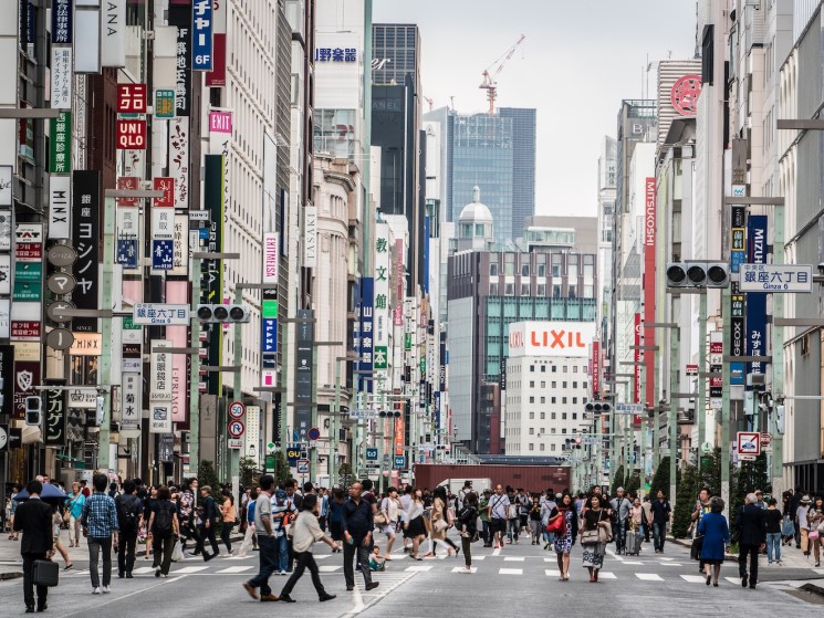 Pedestrians walking on Chuo Dori, a major street in the high-end Ginza shopping and entertainment district.