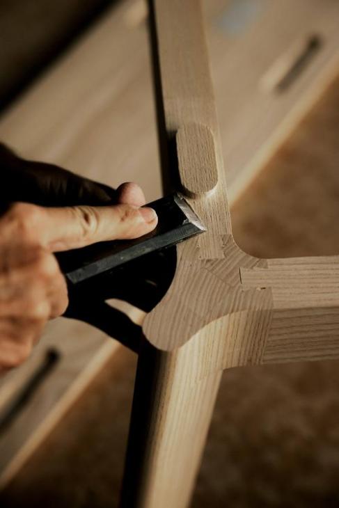 Joint of a wooden object being refined.