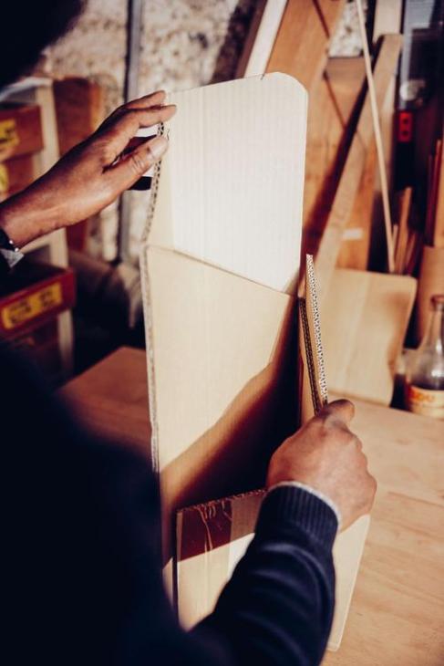 Charles O Job reworking a cardboard model.