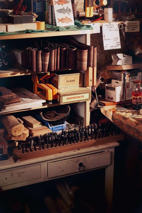 Objects and tools upon a desk.