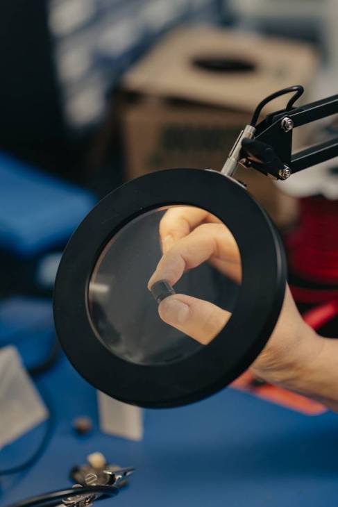 A magnifying glass showing a component. 