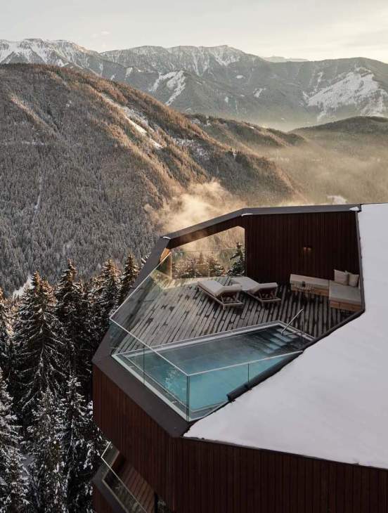 An outdoor swimming pool and balcony area at Forestis.