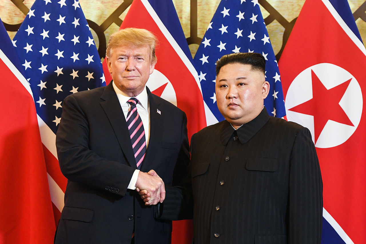 Donald Trump shaking hands with Kim Jong Un