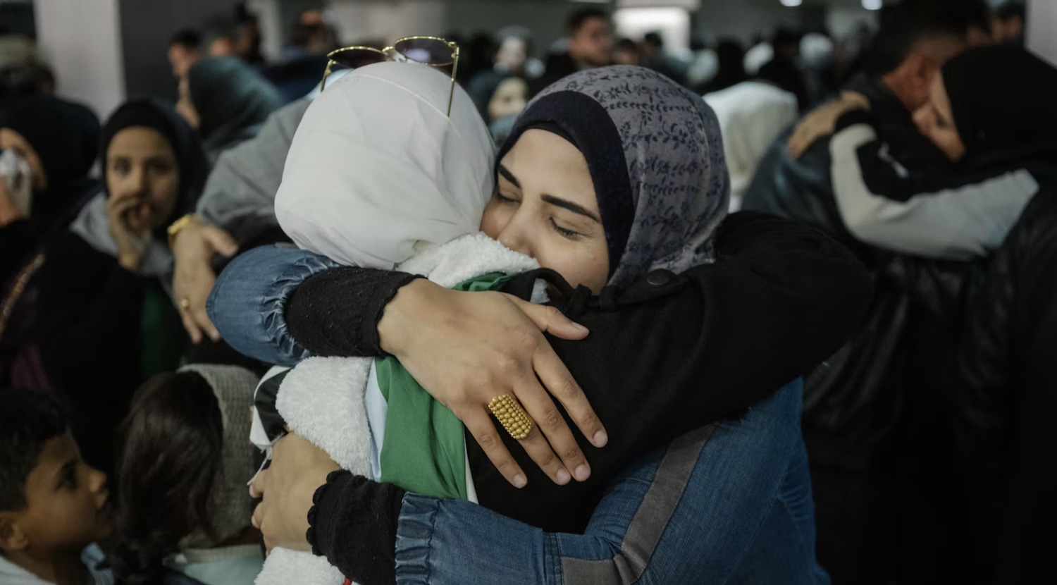 two Syrian women embracing