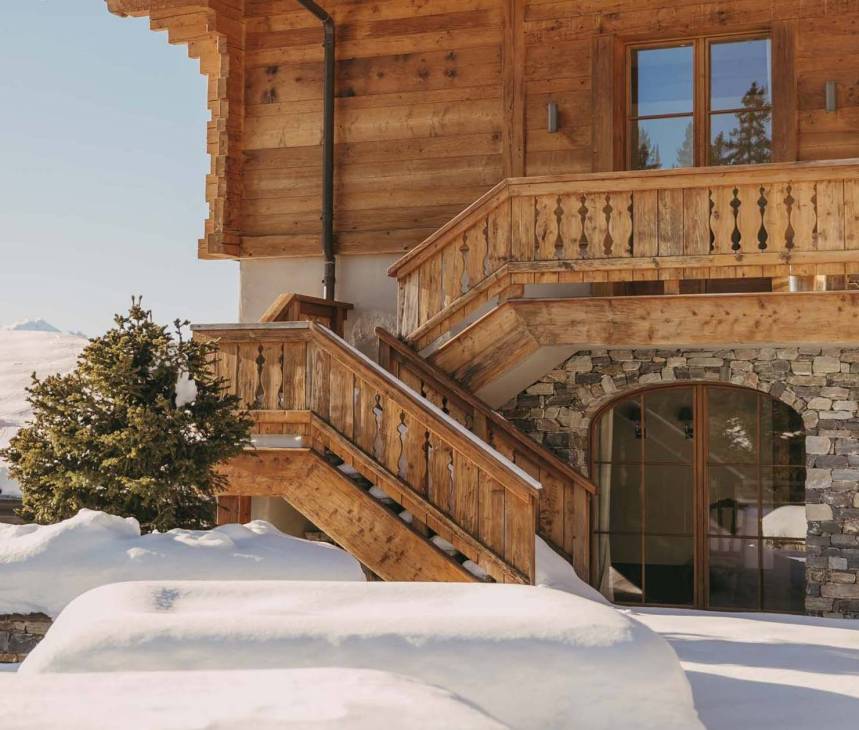 The exterior and staircase of a LeCrans lodge.