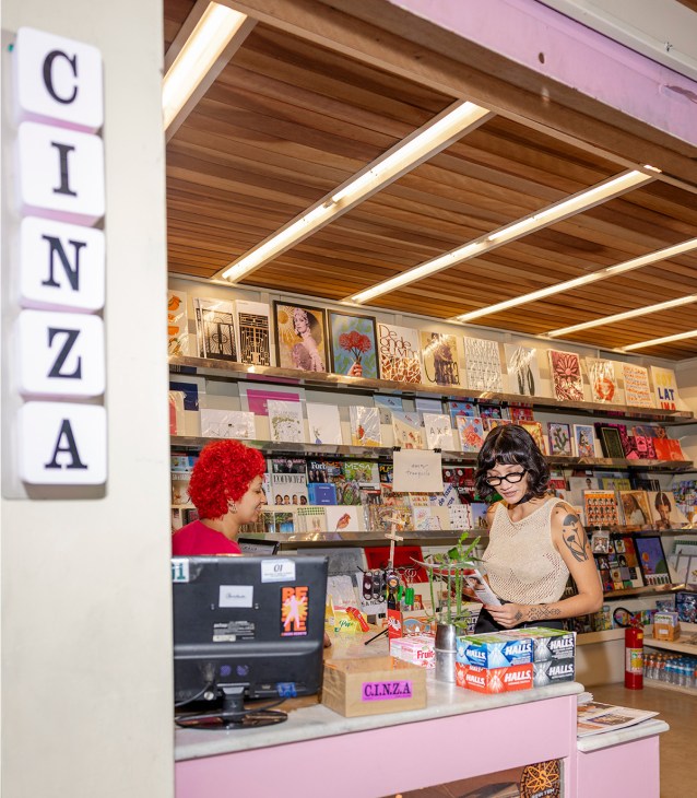 Women looking at magazines in kiosk