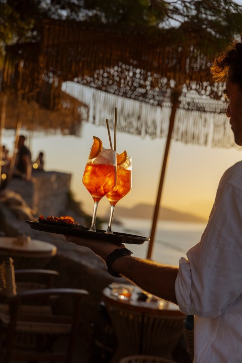 A waiter carrying drinks on a tray