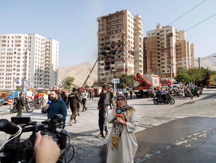 Damage report: Journalists at the scene of a residential complex in Tehran hit by Israeli strikes
