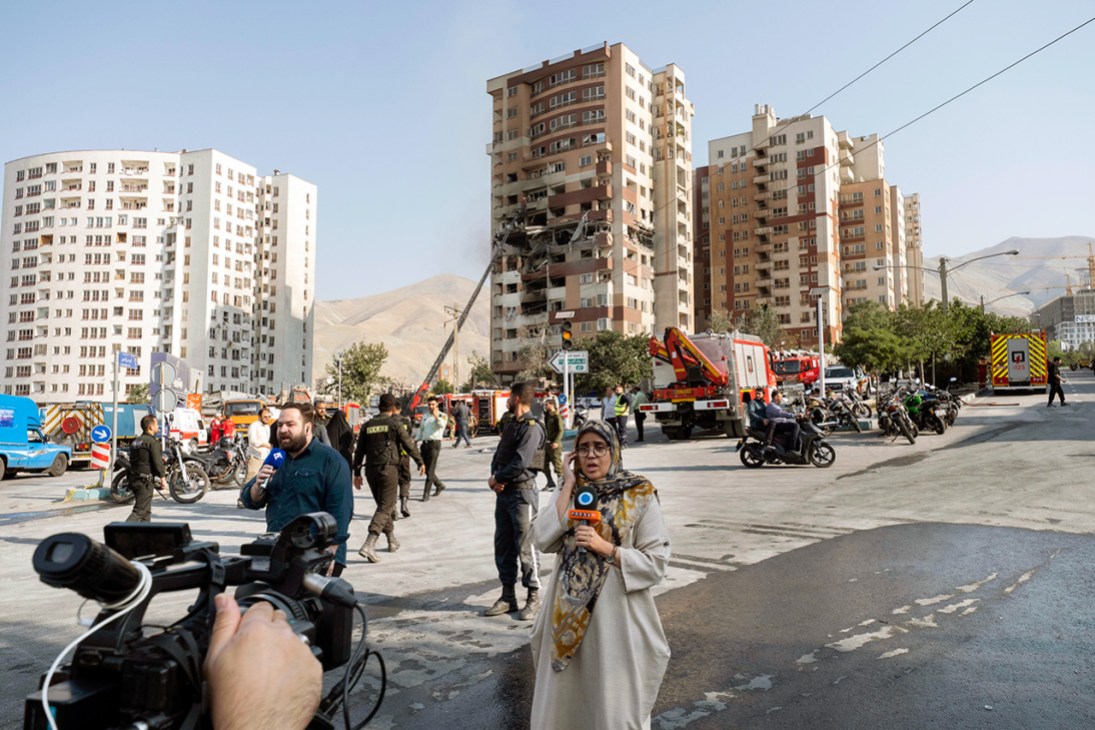 Damage report: Journalists at the scene of a residential complex in Tehran hit by Israeli strikes