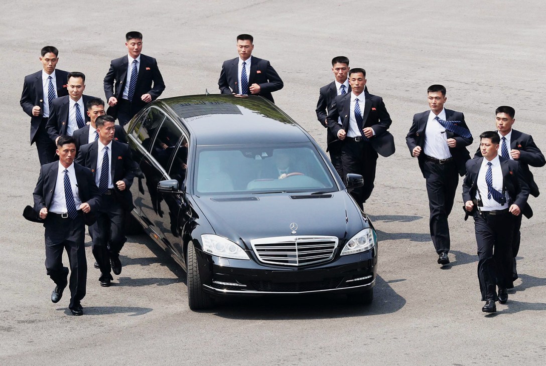 Dressed to overkill: North Korean bodyguards jog next Kim Jong-Un’s limo