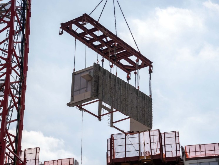 A construction crane is lifting a Modular Integrated Construction module at a construction site for a public housing project in Hong Kong, China, on December 4, 2023. Hong Kong Modular Integrated Construction For Public Housing - 05 Dec 2023