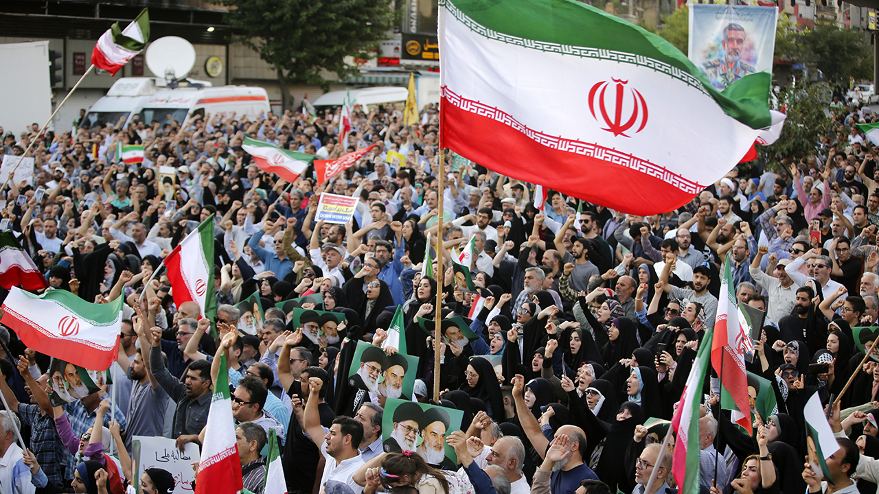 Crowds holding Iranian flags gather in the Revolution Square in the capital Tehran to protest the US attacks on three nuclear facilities in Iran on June 22, 2025