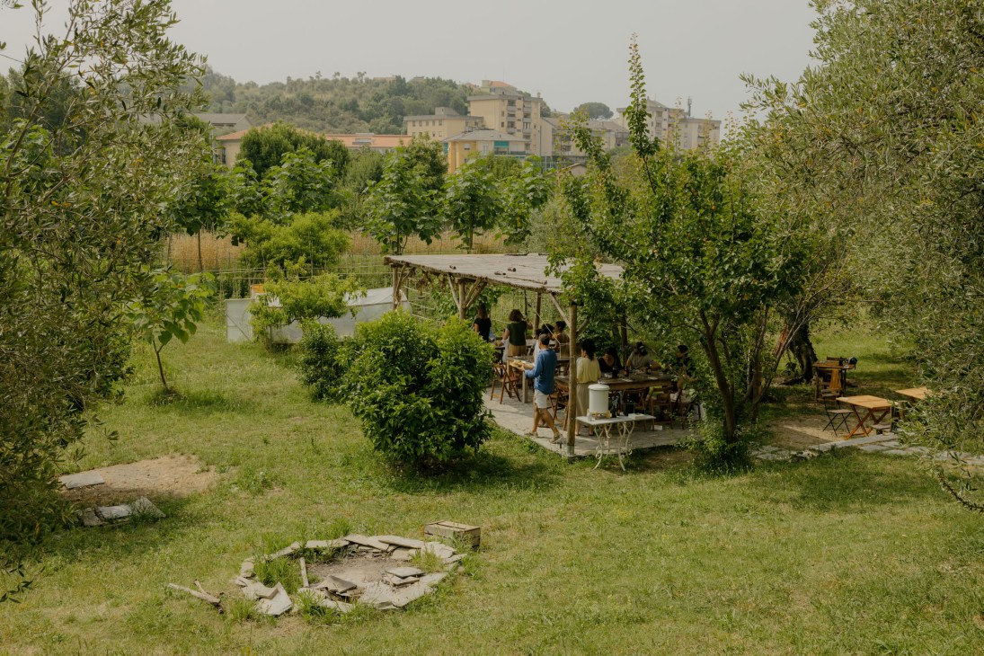 People dining under shade in the garden