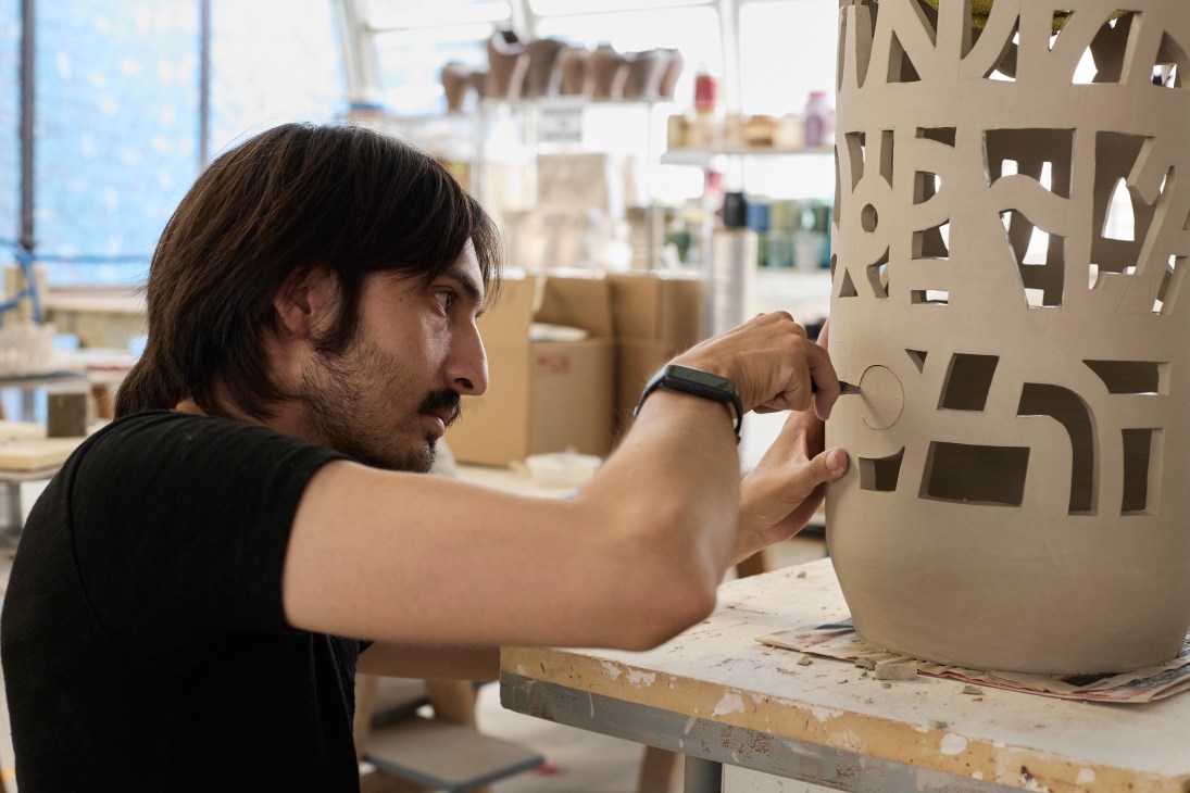 Person making a ceramic sculpture