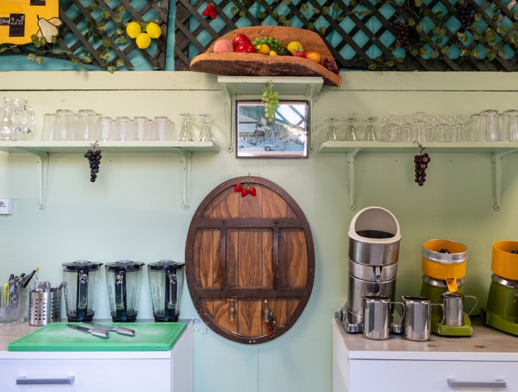 Yannis Amarkaze, owner of Station Uvale du Palais serves fresh pressed juice made from Cardinal grapes at his kiosk. Friday, Aug. 25, 2023. Marseille, France, ©Annie Etheridge