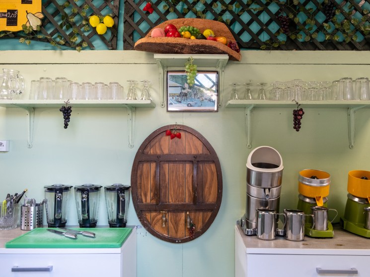Yannis Amarkaze, owner of Station Uvale du Palais serves fresh pressed juice made from Cardinal grapes at his kiosk. Friday, Aug. 25, 2023. Marseille, France, ©Annie Etheridge