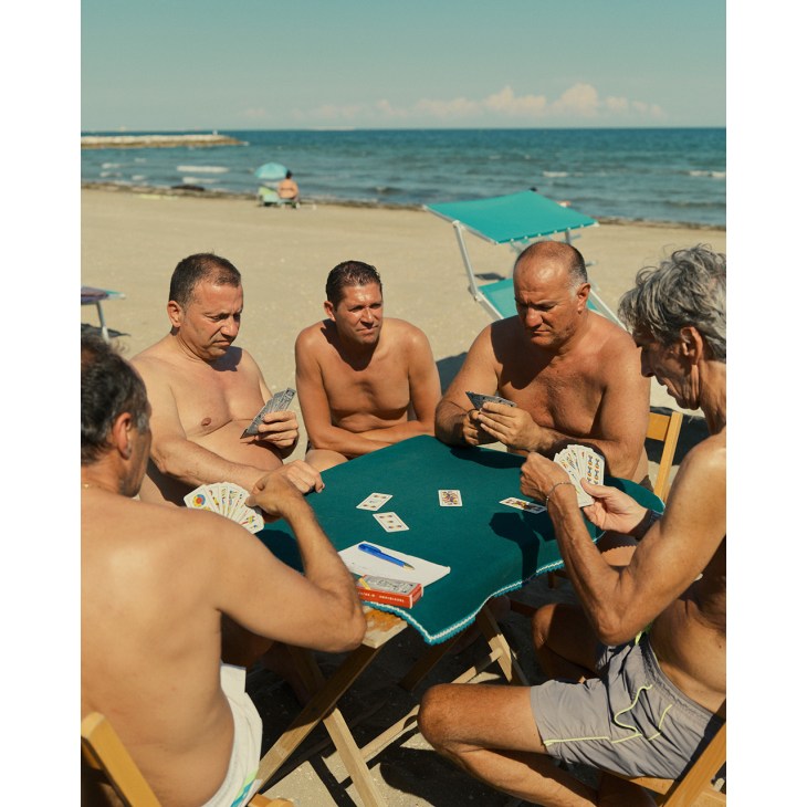 Men playing cards at the beach