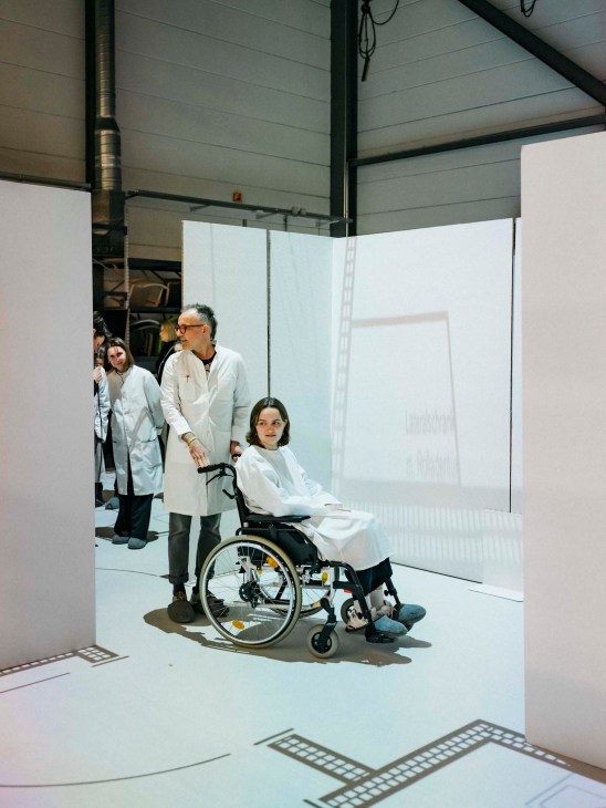 A woman in a wheelchair in the mock hospital
