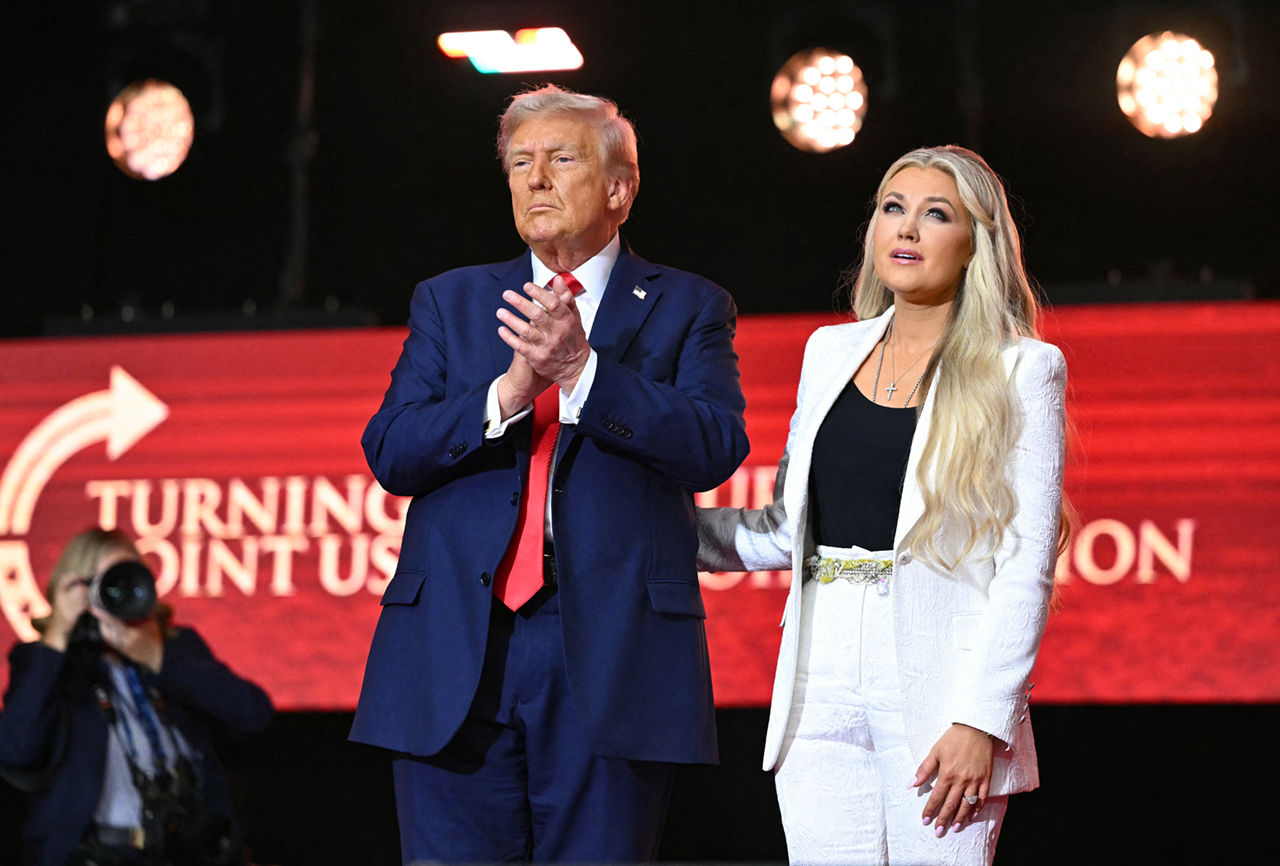 US President Donald Trump reacts next to Erika Kirk, widow of Charlie Kirk, after speaking at the public memorial service for right-wing activist Charlie Kirk at State Farm Stadium in Glendale, Arizona, on September 21, 2025. (Photo by Mandel NGAN / AFP) (Photo by MANDEL NGAN/AFP via Getty Images)