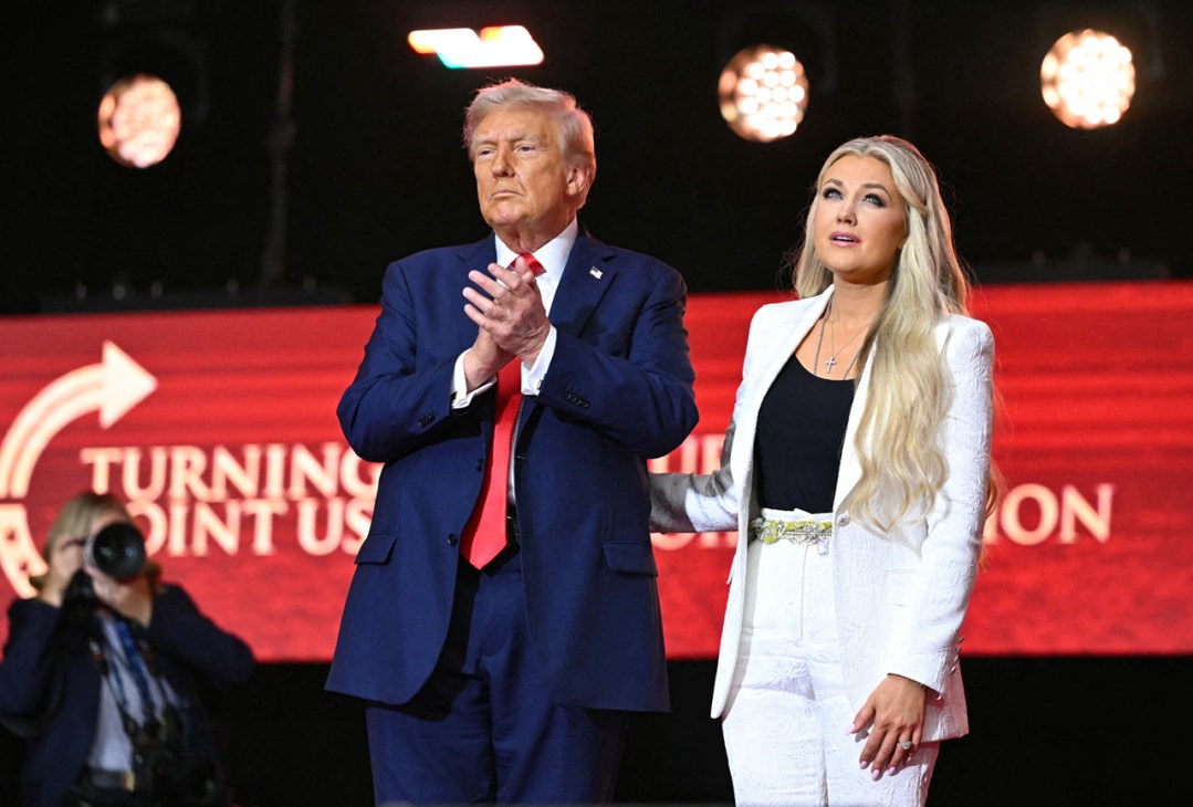 US President Donald Trump reacts next to Erika Kirk, widow of Charlie Kirk, after speaking at the public memorial service for right-wing activist Charlie Kirk at State Farm Stadium in Glendale, Arizona, on September 21, 2025. (Photo by Mandel NGAN / AFP) (Photo by MANDEL NGAN/AFP via Getty Images)