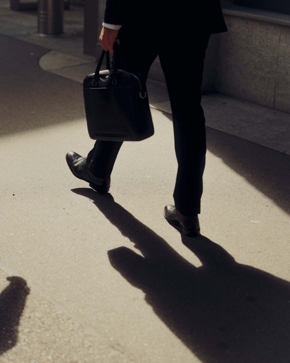 A person holding a briefcase shot by Sigma BF