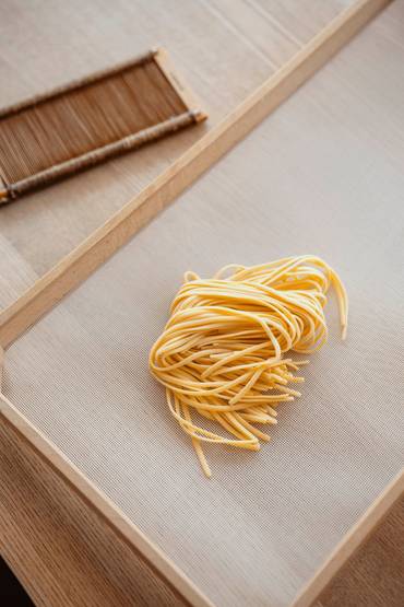 Fresh pasta on a rolling board.