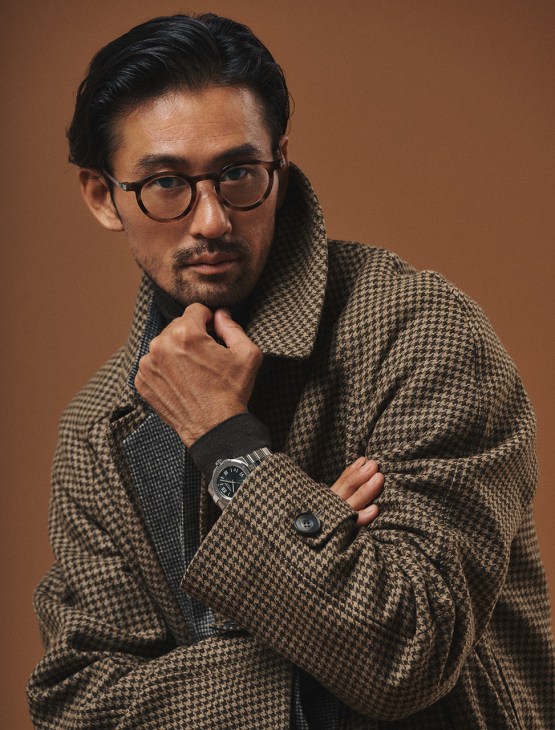 Male model in Heugn jacket, Hermès jumper and Lindberg glasses