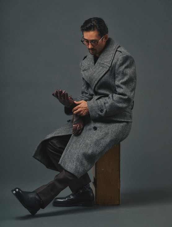 Male model in coat, jumper, trousers,
boots and gloves by Burberry,
glasses by Lindberg