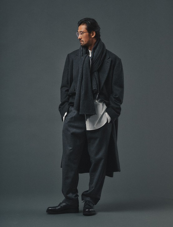 Male model in coat by Comoli,
trousers by Engineered Garments,
shirt by TakahiroMiyashitaTheSoloist,
shoes by Church’s, glasses by Lindberg,
scarf by Contempo