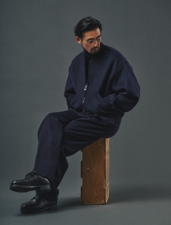 Male model in jacket and trousers by
Emporio Armani, rollneck jumper
by Uniqlo, shoes by JM Weston,
glasses by Lindberg