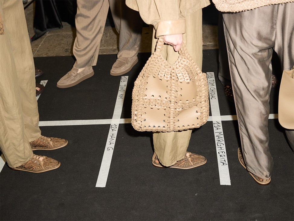Guest holds a bag at Giorgio Armani’s farewell show at Milan Fashion Week