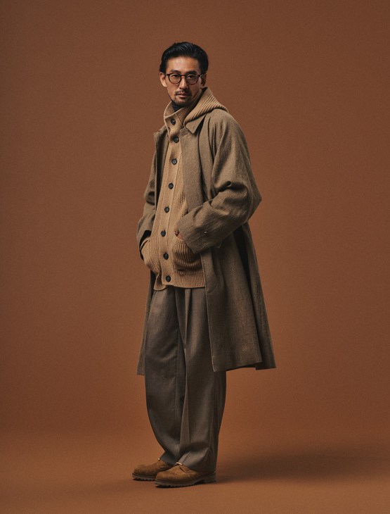 Male model poses in Kaptain Sunshine coat and trousers