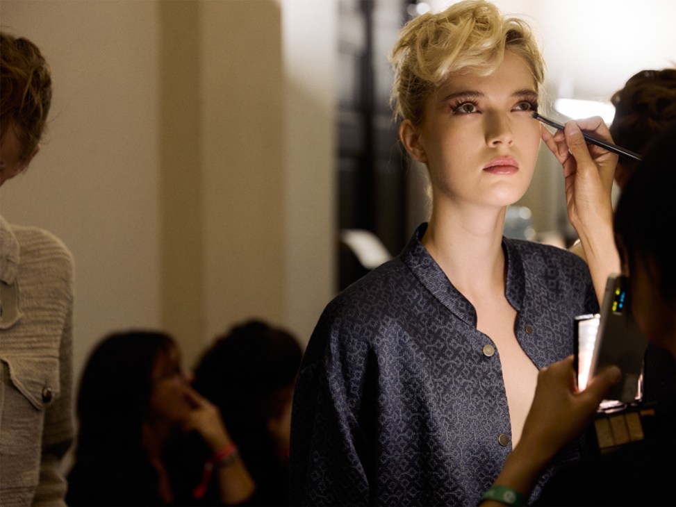Model gets makeup applied at Giorgio Armani’s farewell show at Milan Fashion Week