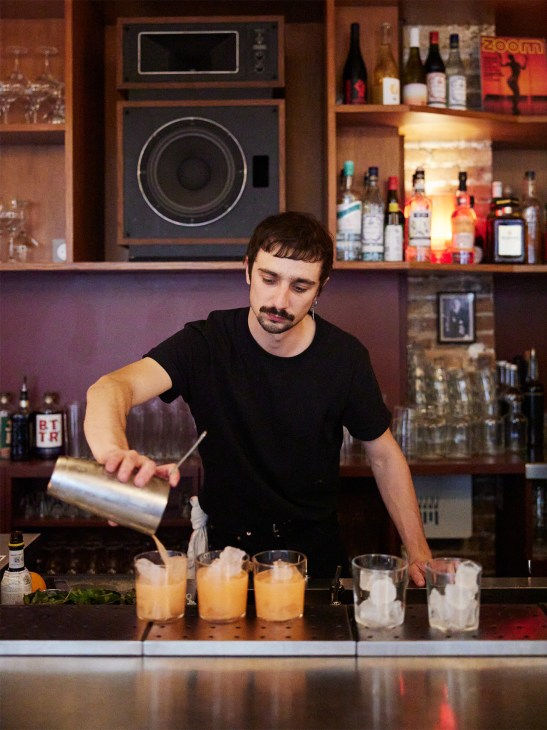 bartender pours drinks at La Patate Douce, Paris