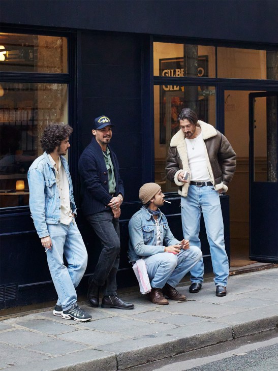 A group of customers stand outside La Patate Douce listening space in Paris