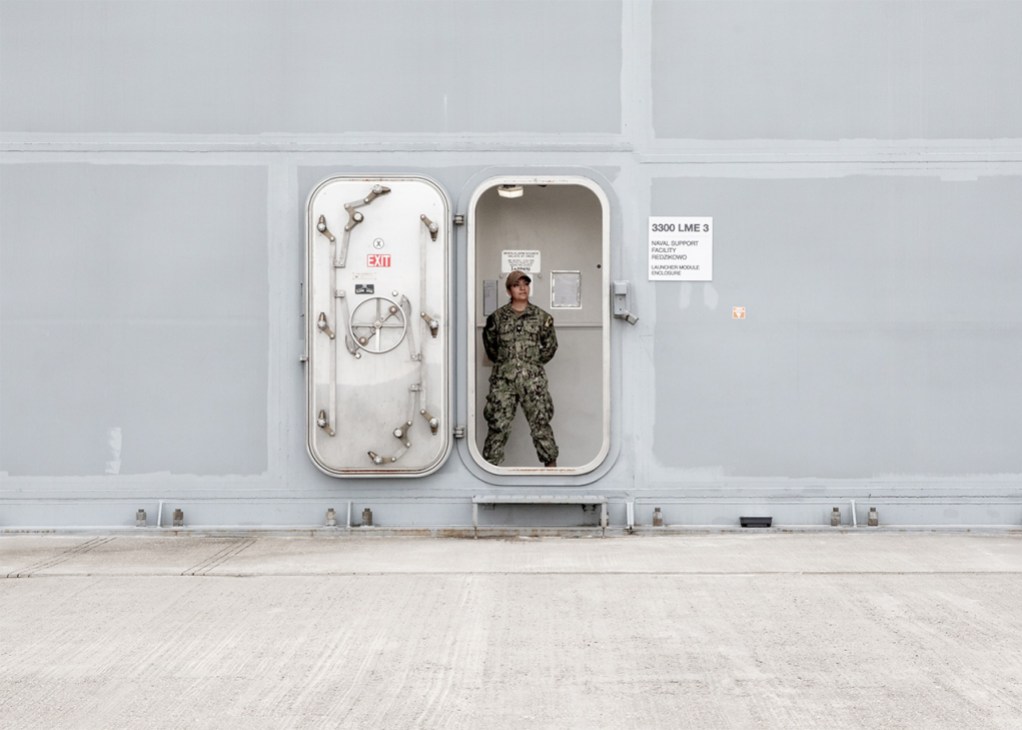 Soldier stands in entrance of building housing the SM-3 interceptors in Poland
