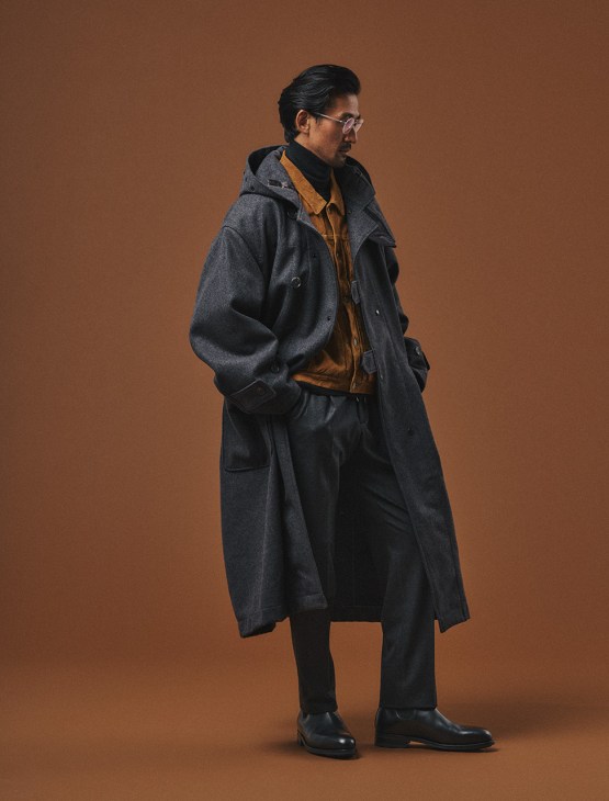 Male model in coat by Engineered
Garments, jacket by Visvim, rollneck
jumper by Uniqlo, trousers by Briglia
1949, boots by JM Weston, glasses by
Lindberg